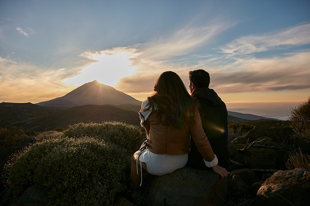 Couple sitting at sunset on the VIP Astronomic Tour