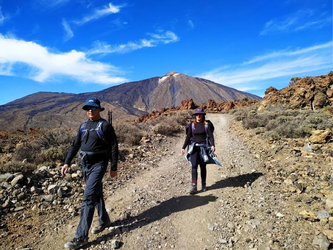 Hikers on foot with Mount Teide in the background in Tenerife